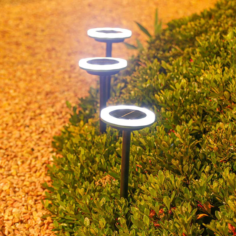 Solar-powered rotating lawn light with 12 LEDs in garden setting