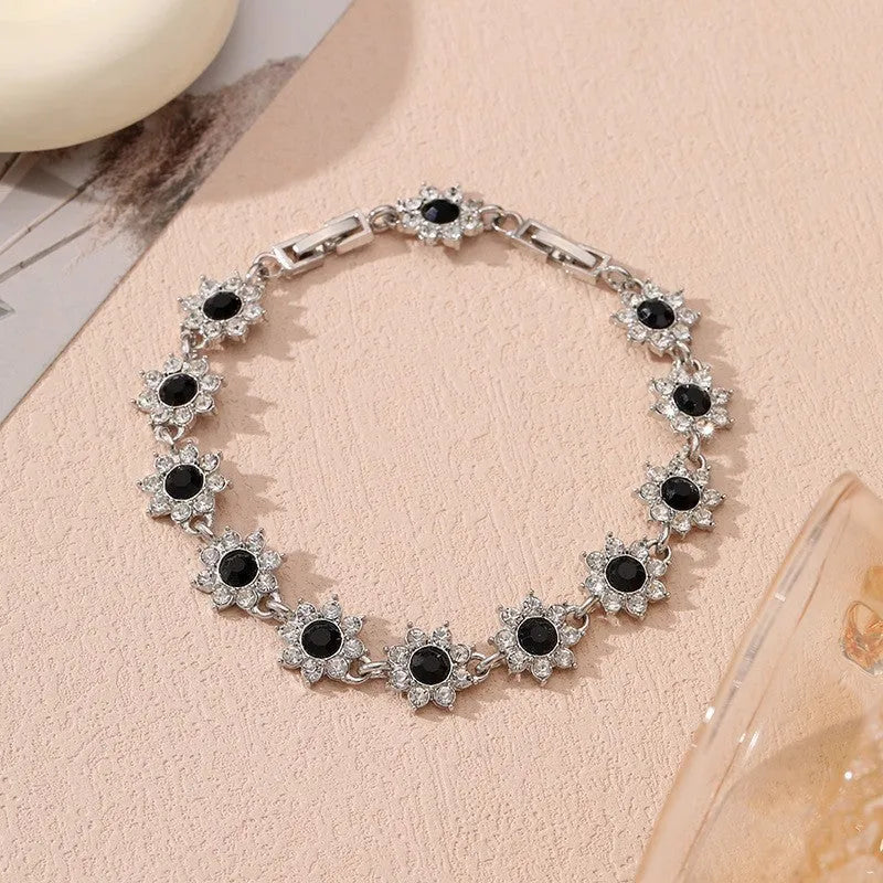 Luxury style bracelet with coloured gems and floral design on zinc alloy with electroplated finish
