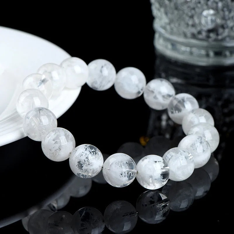Crystal women's bracelet with natural blizzard snowflake round beads in geometric shapes showing traditional Ruyi and Xiangyun motifs