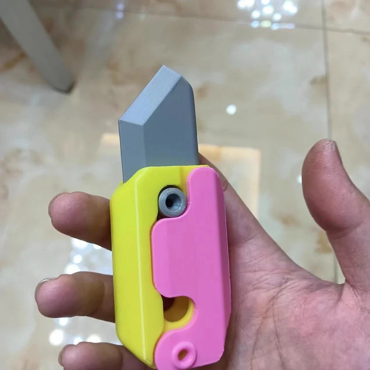 Radish-shaped 3D printed gravity knife, a portable and fun stress relief toy with a hidden blade that springs out with a flick of the wrist