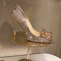 Gold women's pointed toe stiletto heels with sequin and rhinestone decoration on a shallow mouth.