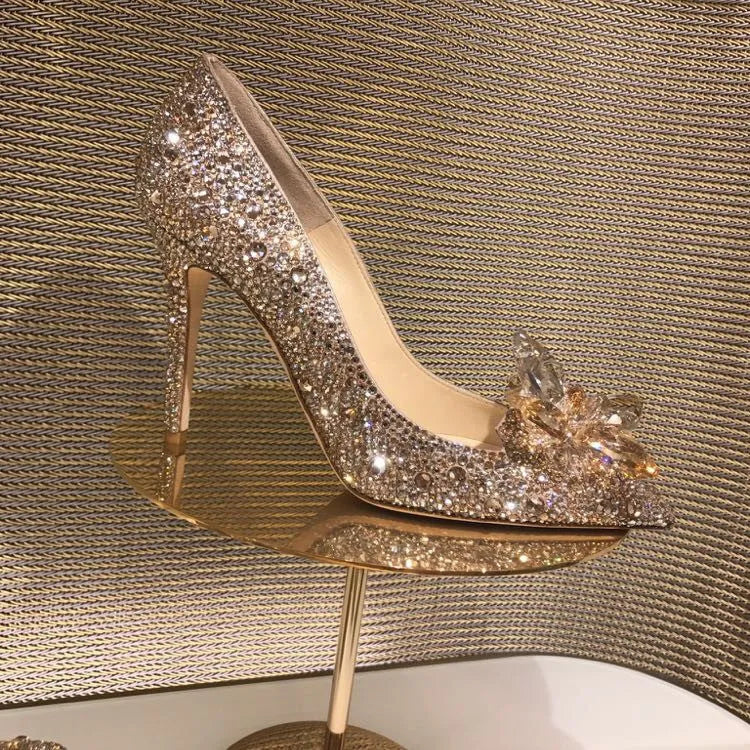 Gold women's pointed toe stiletto heels with sequin and rhinestone decoration on a shallow mouth.