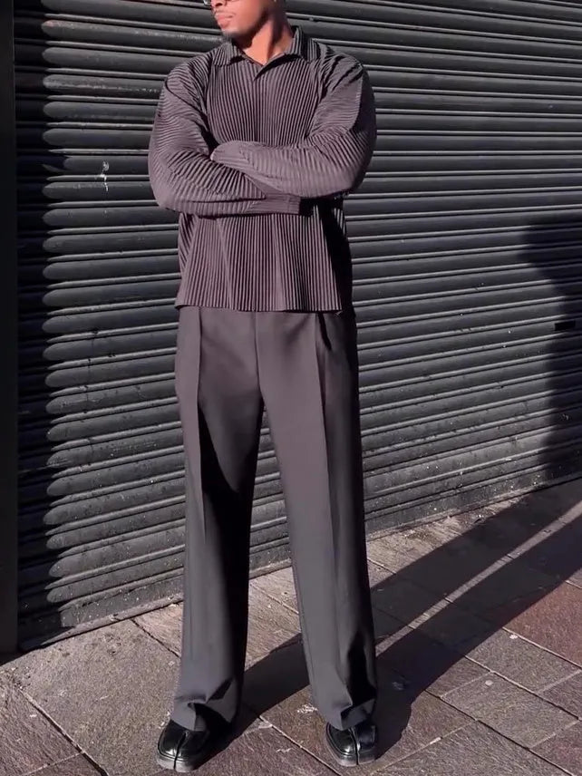 Men's black polyester long-sleeved top with pleated design detail showing regular fit and long sleeves