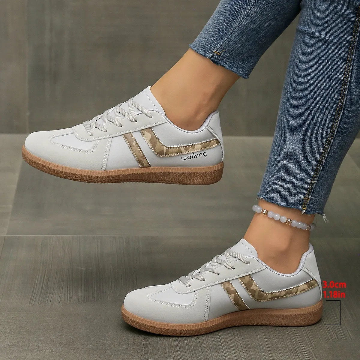 Plus size low-top sneaker in artificial PU with flat rubber sole and lace-up front, shown in multiple colour options.