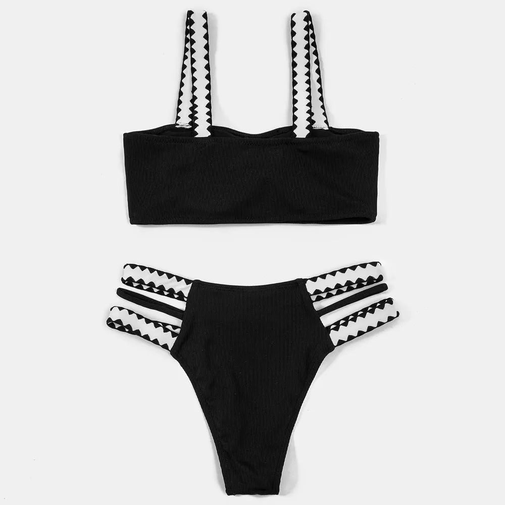 Black women's hollowed-out split swimsuit bikini set on a mannequin.