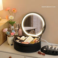 Round pink PU leather LED makeup bag open showing internal mirror, lights, and lattice partitions.