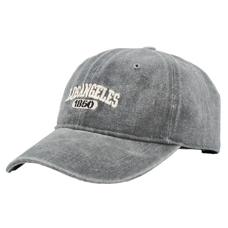 Retro distressed acrylic cap with embroidered letters, shown in beige colour with adjustable strap.