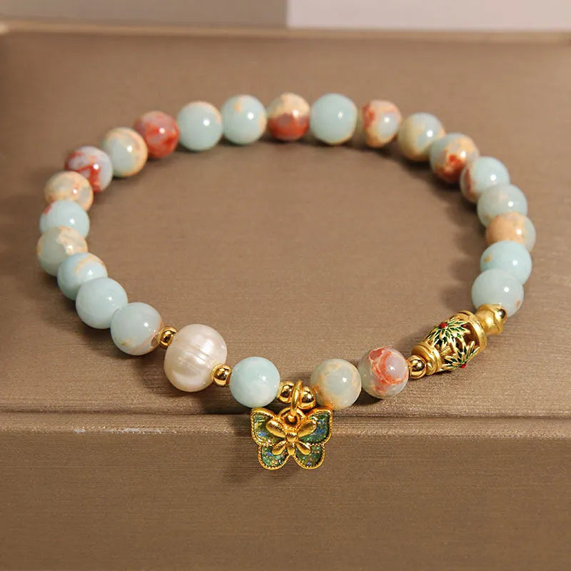 Blue women's bracelet with butterfly pendant containing Shoushan stone and freshwater pearls.