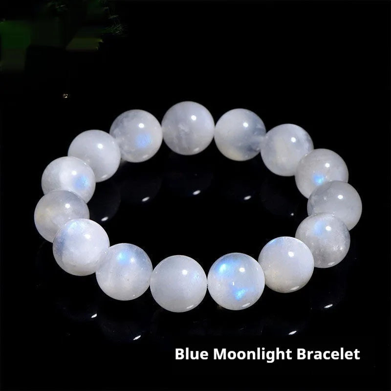 Natural blue moonlight round moonstone bead bracelet on a wrist, showing polished gemstone surface.