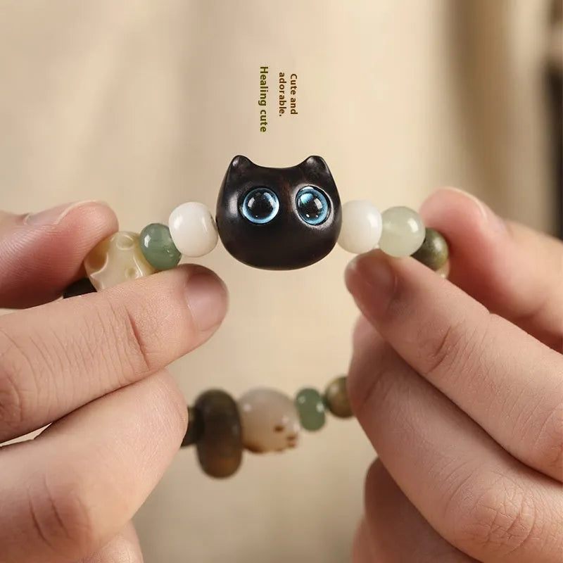 Hand-woven beaded bracelet with jade, bodhi and wood cubes and a wooden Sugar Cat's Paw charm.