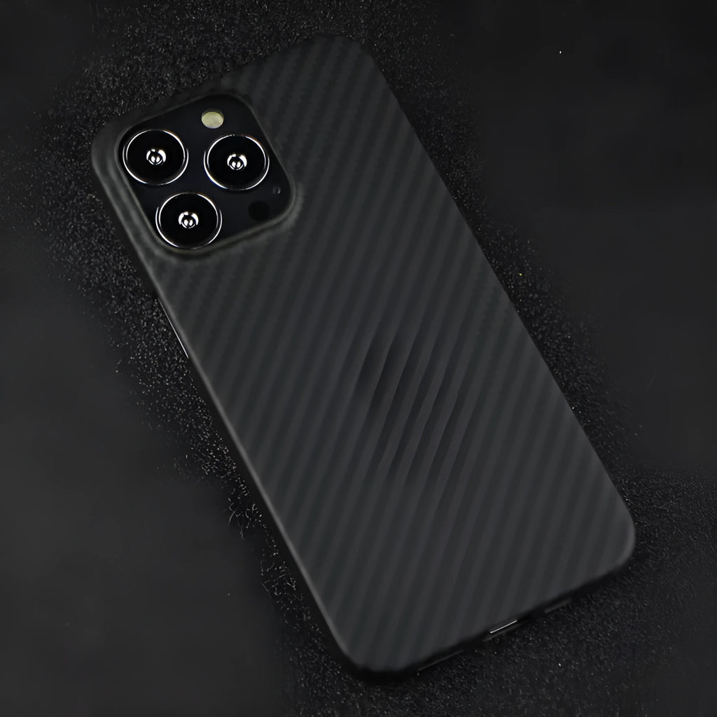 Dull black Kevlar fibre iPhone case with textured volcanic crater pattern and MagSafe magnetic rings