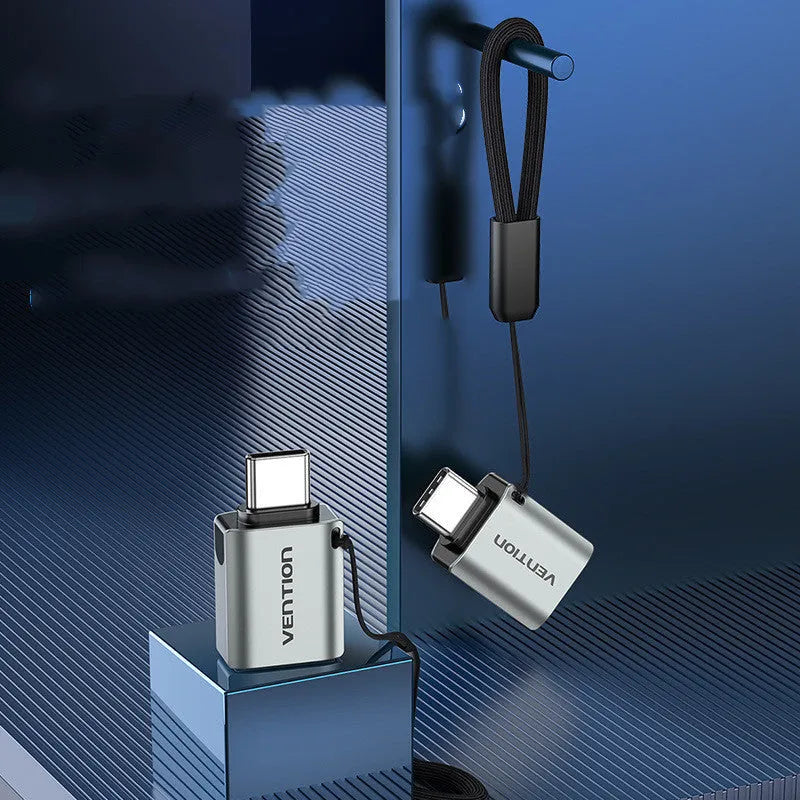 Grey aluminium USB 3.0 C Male to A Female OTG adapter with attached lanyard.