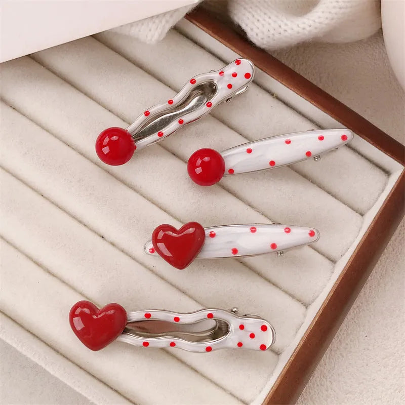 Red love heart shaped hair clip with dotted patterns and willow leaf designs on a barrette