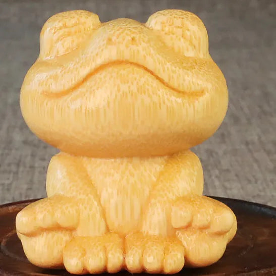 Solid bamboo smiling frog carving ornament measuring 5cm high with 120ml oil glove brush.