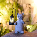 Solar garden light shaped like a kitten lifting a lamp, made from resin for outdoor decoration.