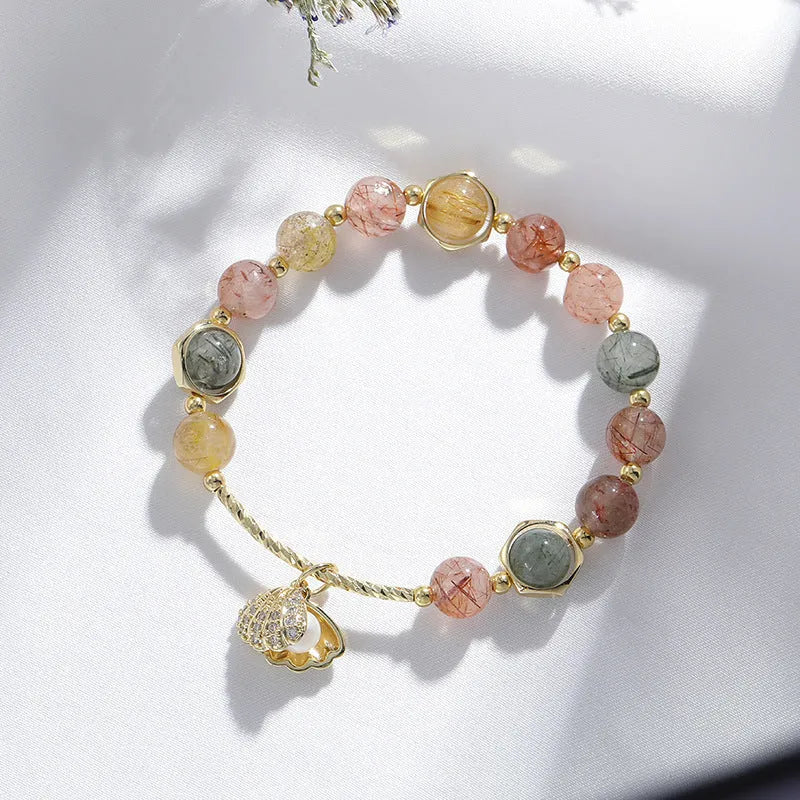 Colourful crystal shell bracelet with red sealant flower designs and animal zodiac motifs