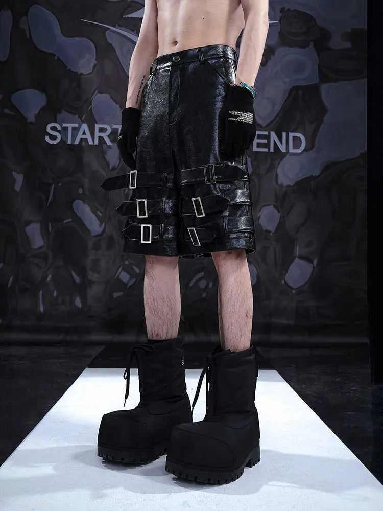 Black men's PU leather cropped shorts with leather ring detailing on a model