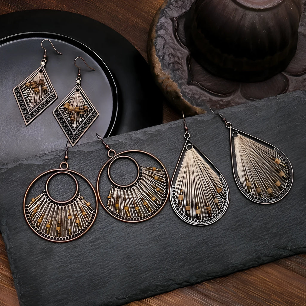 Bohemian hand-woven gold thread alloy earrings with geometric quadrilateral shape on a white background