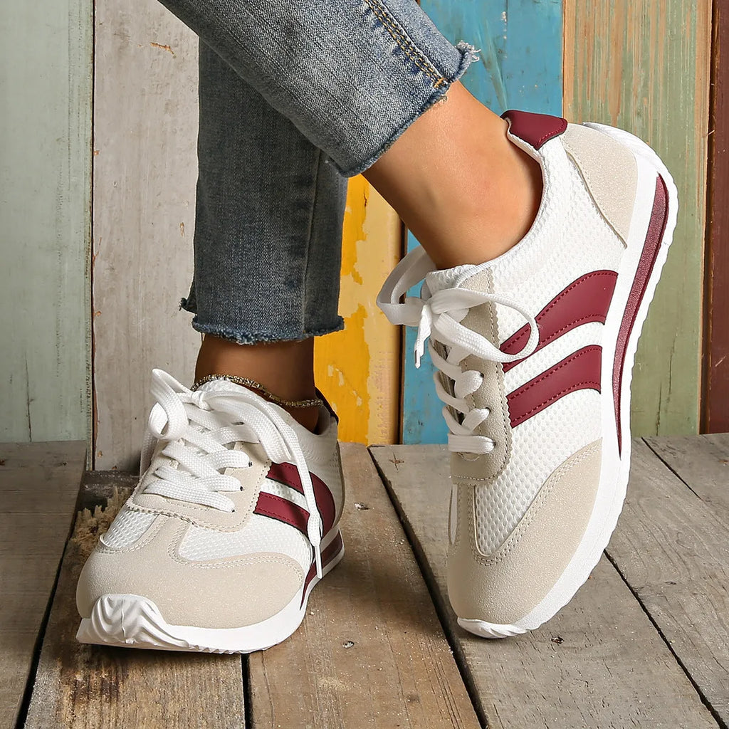Wine red Cortez retro sneaker with cross strap and breathable mesh surface.