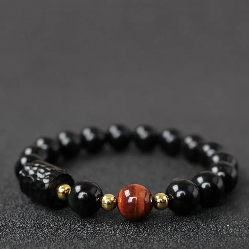 Obsidian bracelet with tiger eye beads in 10mm size showing manual craftsmanship and unisex design