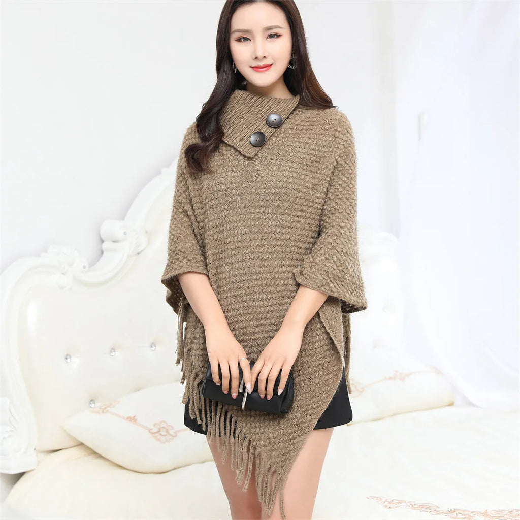 Sleeveless knitted cloak shawl with dot pattern, shown in apricot colour