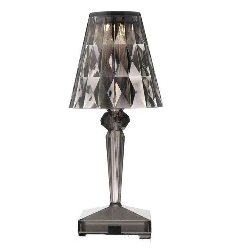 Rose gold portable touch night light on a surface showing its dimmable glow.