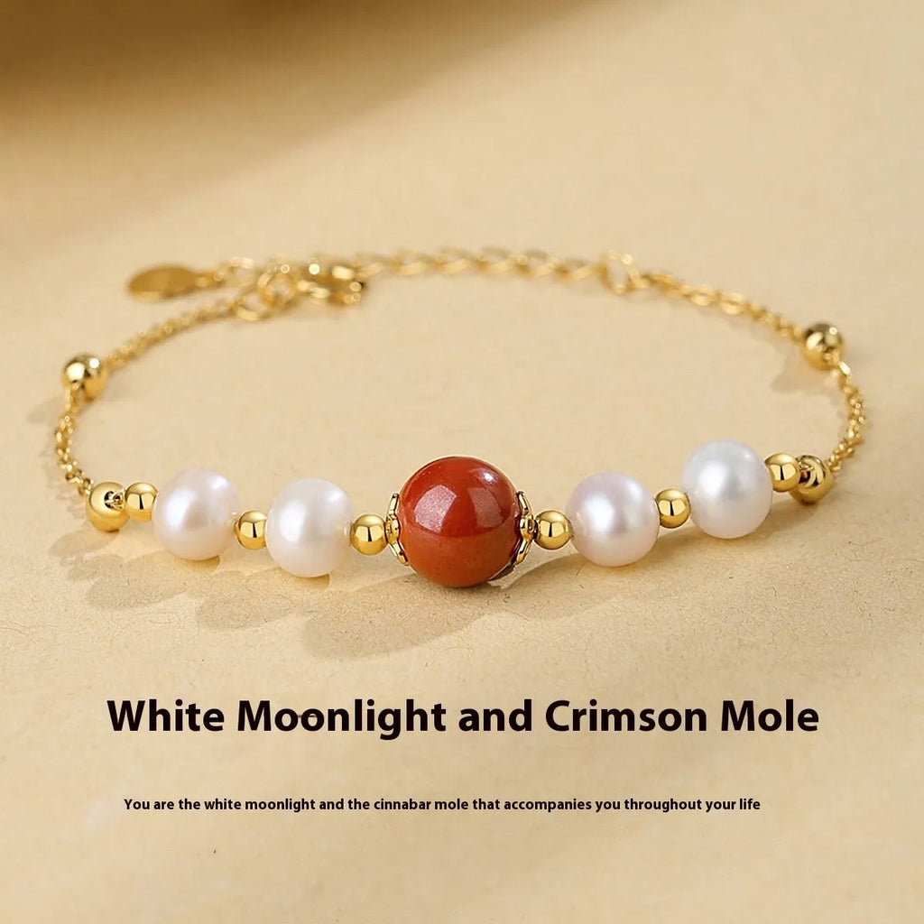 Yellow retro-style bracelet with red cinnabar beads and white pearls on a silver chain.
