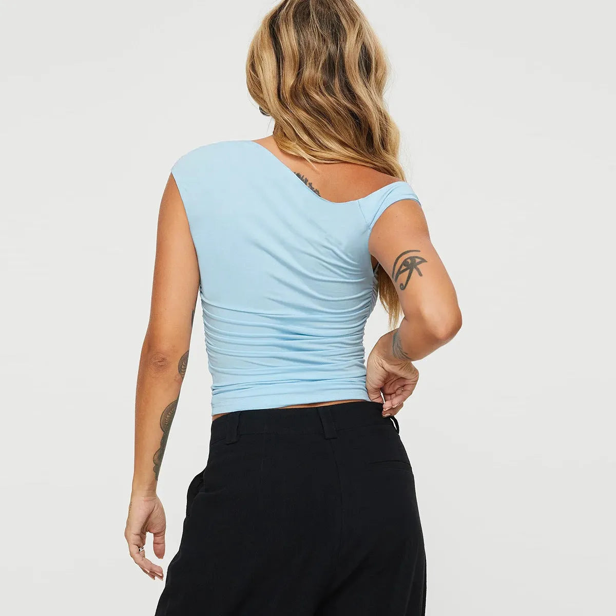 Women's light blue sleeveless oblique collar pleated slim-fit top on model