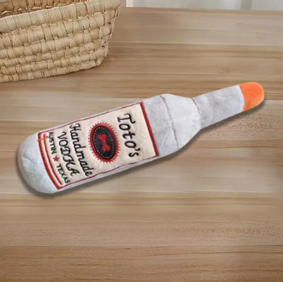 Brown plush wine bottle shaped dog toy with textured molar surface and squeaker