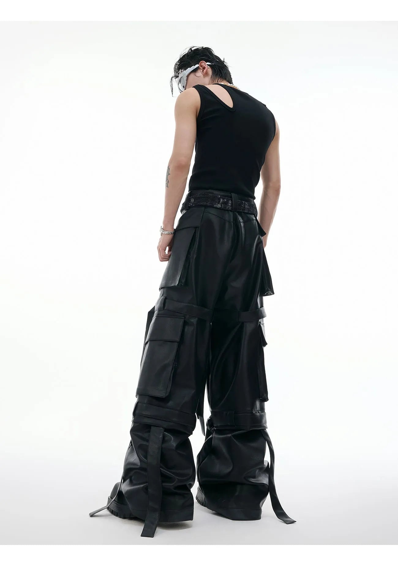 Black loose fit trousers with multi-pocket stitching and ribbon leather detailing on heavy composite fabric