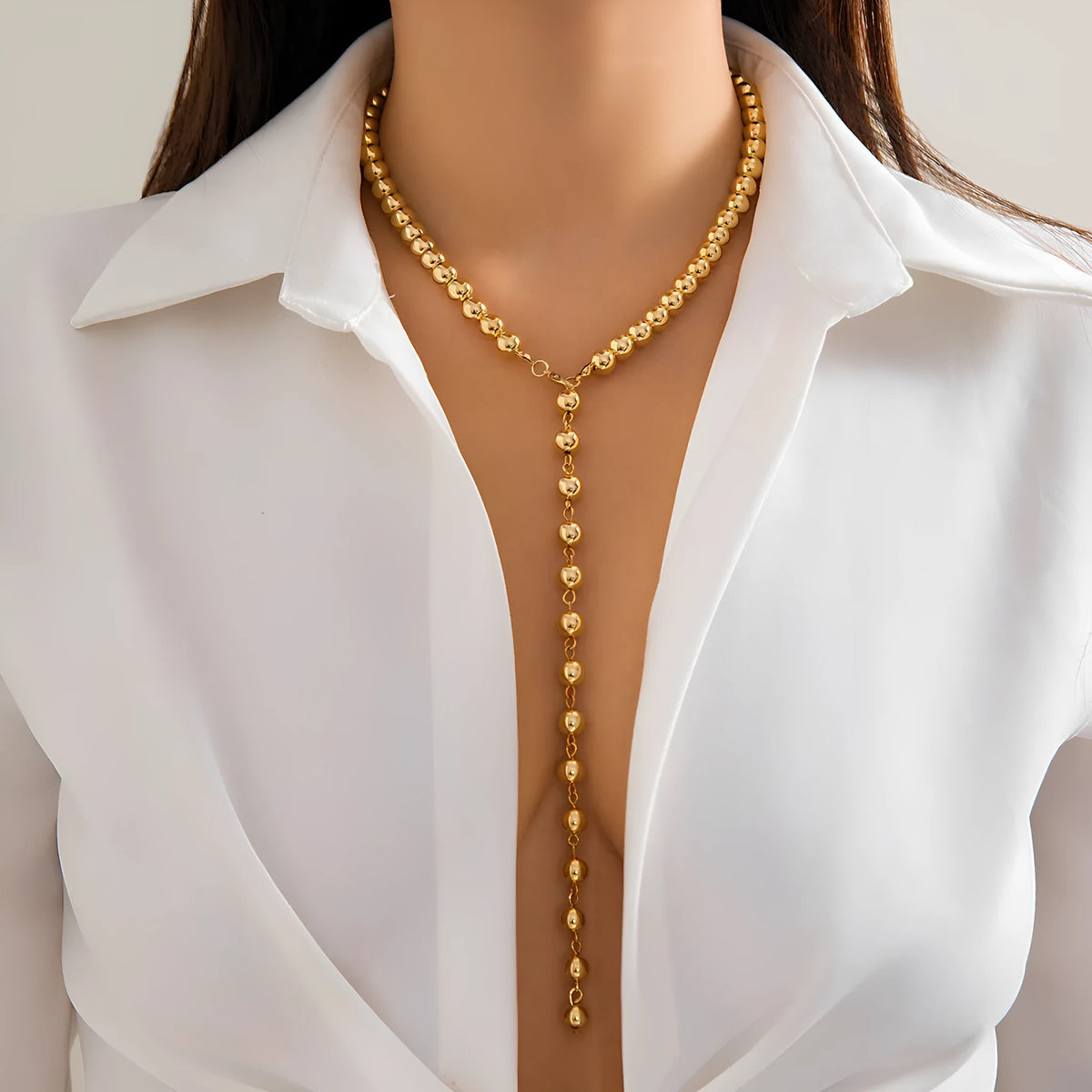 Round bead chain imitation pearl pendant necklace in gold tone with metal construction