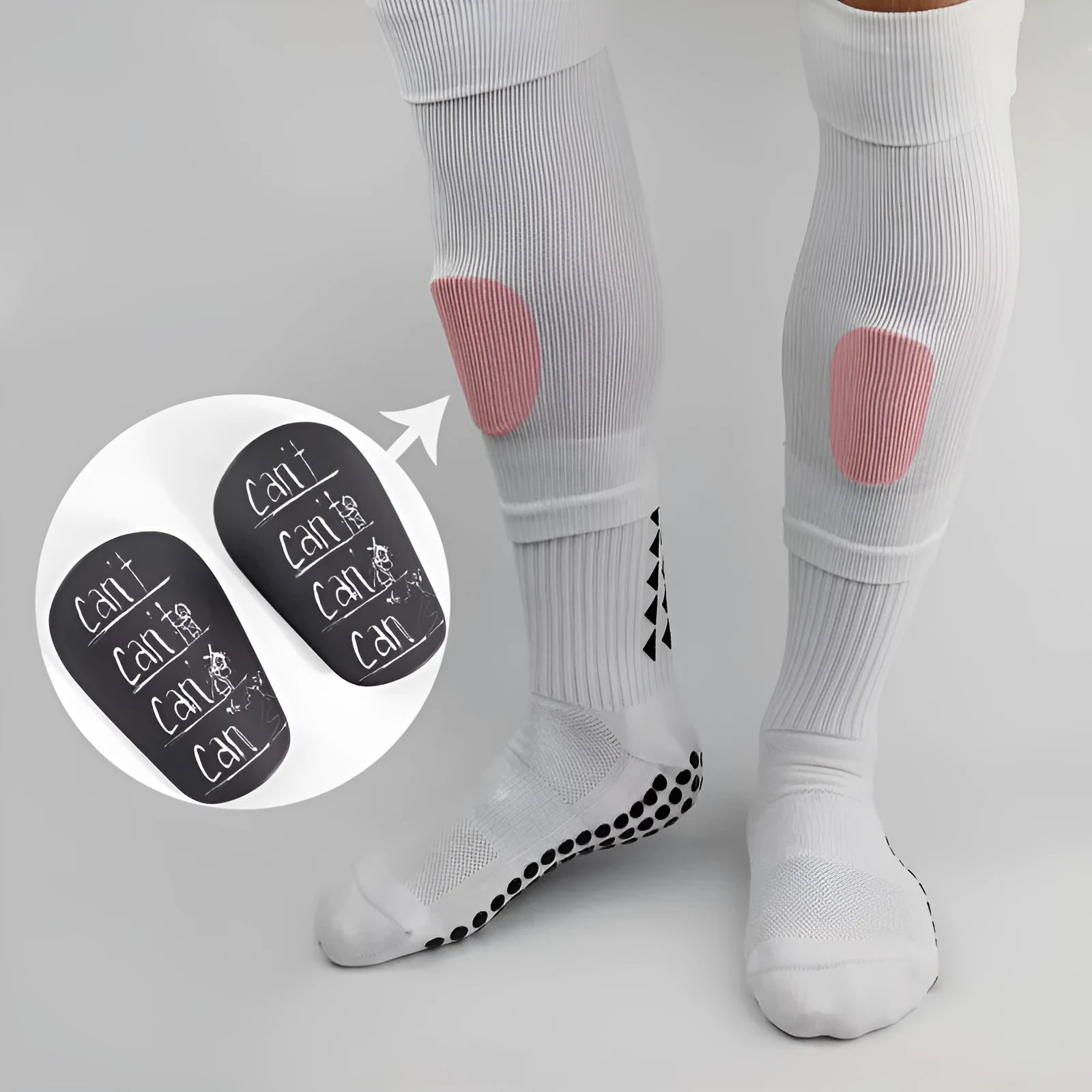Pair of PU football shin guards in black, shown on a leg, for training and sports protection.
