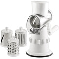 White 3-in-1 manual vegetable slicer and grater with suction feet on a kitchen counter.
