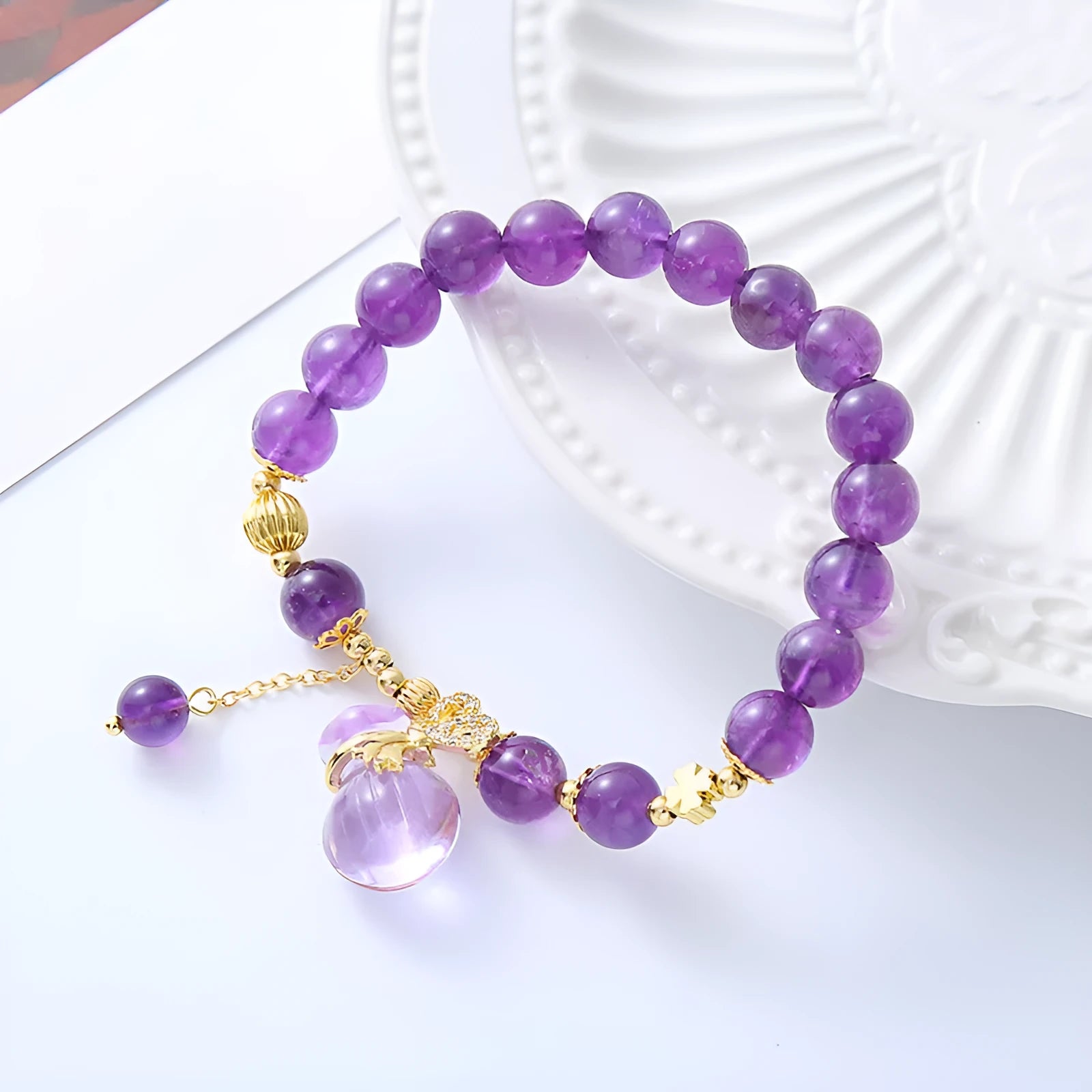 Purple crystal bracelet with geometric shapes, money bag pendant and peace buckle on wrist