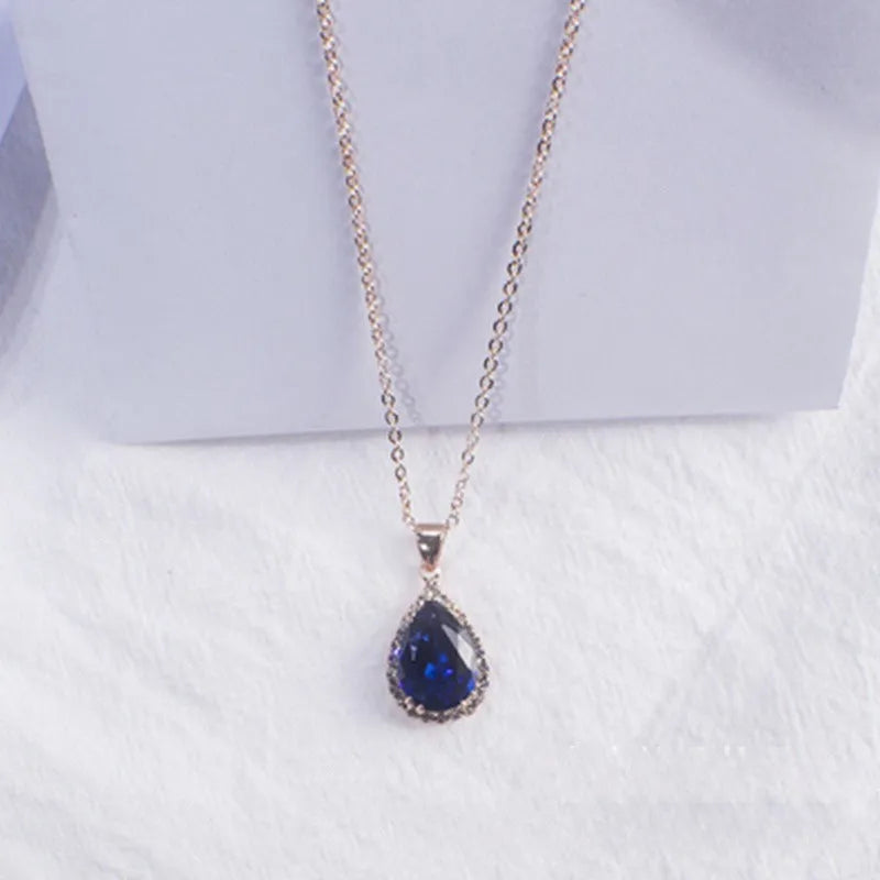 Women's pink alloy water drop necklace with geometric design and rose gold rhinestones on model