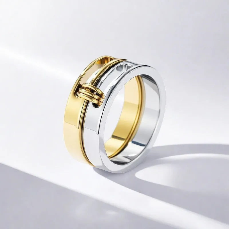 Gold double-layer twin ring made of titanium steel on a plain background