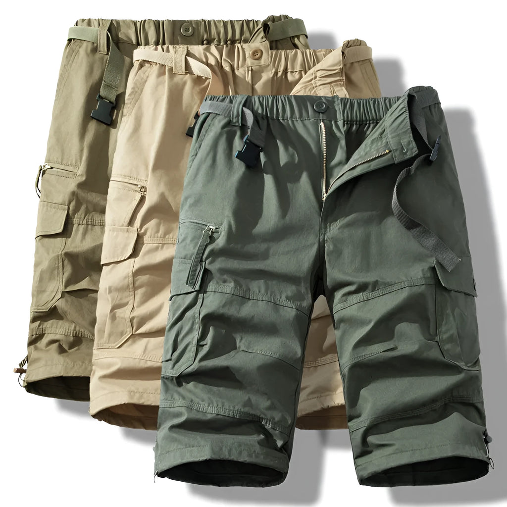 Man wearing thin cotton cropped overalls in army green, showing the relaxed summer fit.