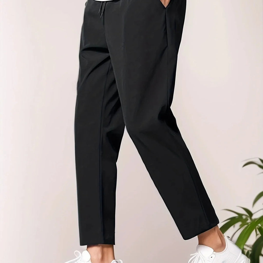 Men's slim fit ankle length trousers in black polyester, tapered leg, mid waist, cropped cut.