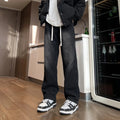 Men's loose fit straight leg denim trousers in blue and black with drawstring waist closure