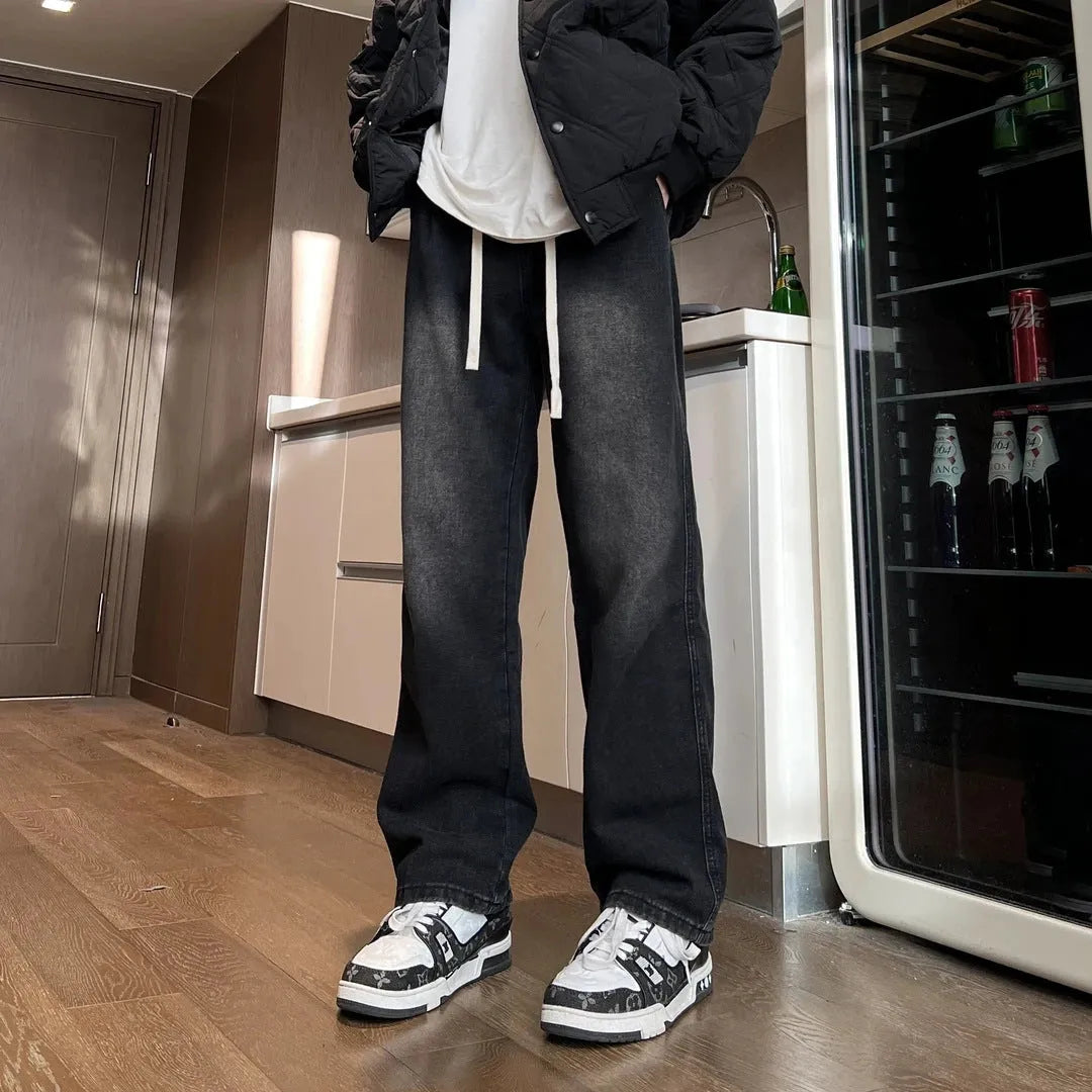 Men's loose fit straight leg denim trousers in blue and black with drawstring waist closure
