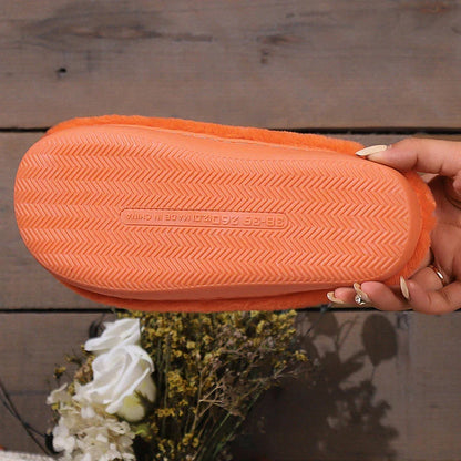 Cozy pumpkin-themed slippers with plush coral velvet upper and non-slip PVC sole for comfortable indoor wear