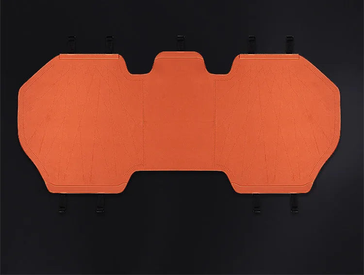 Ultra thin fur car seat cushion in Hermes orange colour with visible ventilation holes and leather backing