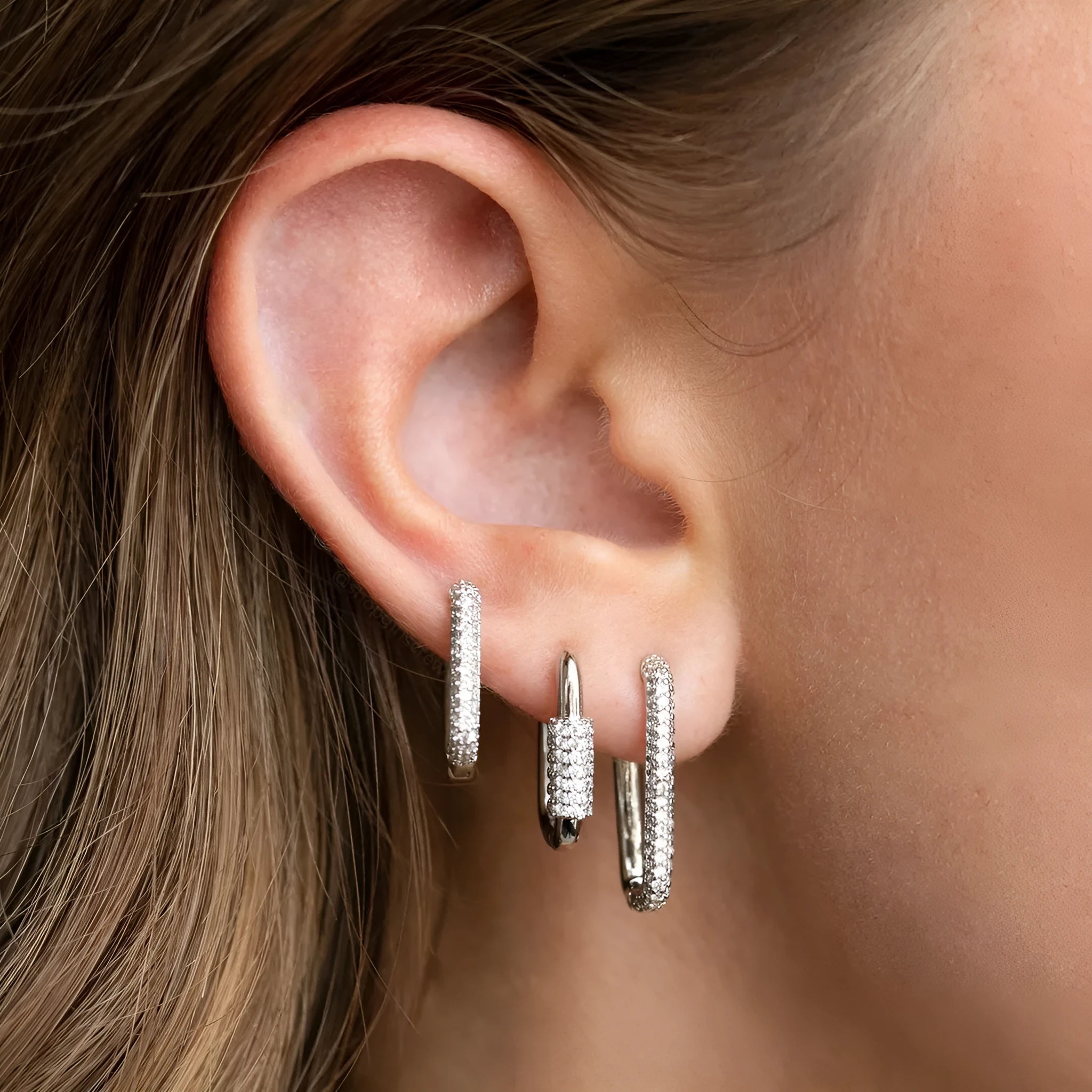 Set of three geometric square clip-on earrings with inlaid zircon detail in gold and white gold tones.