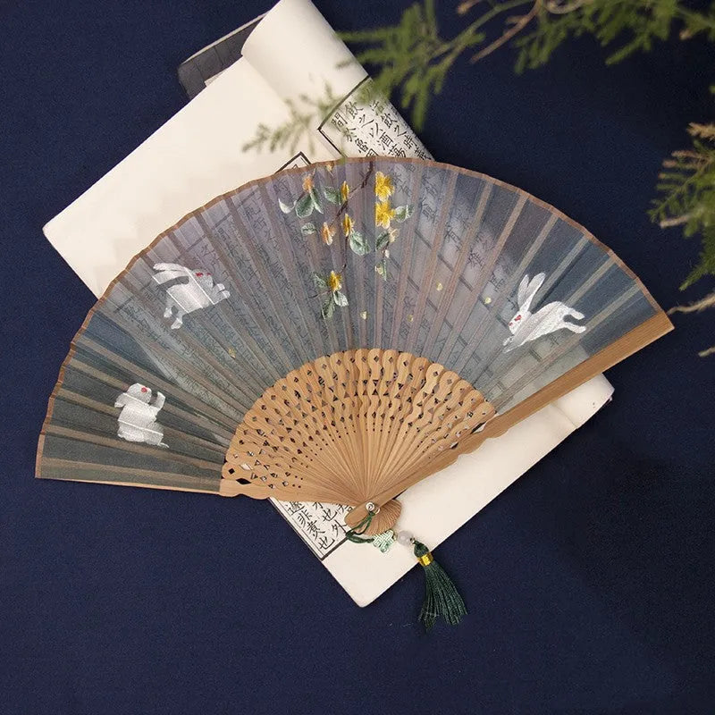 7-inch bamboo folding silk embroidered fan showing traditional Chinese embroidery designs
