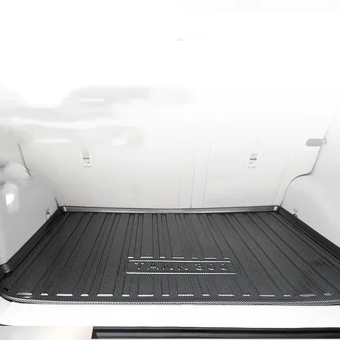 Black car boot liner with carbon fibre pattern texture, made from TPE material.