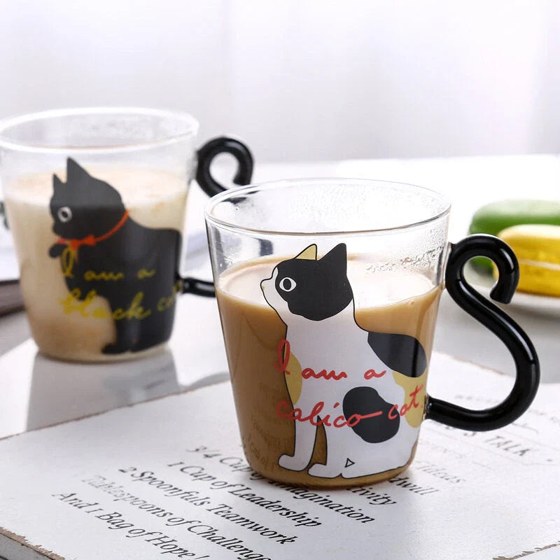 Adorable cat-shaped glass mug with a playful cat tail handle, perfect for coffee, tea, and juice lovers