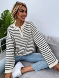 Black striped women's casual top with drop shoulders and button detailing