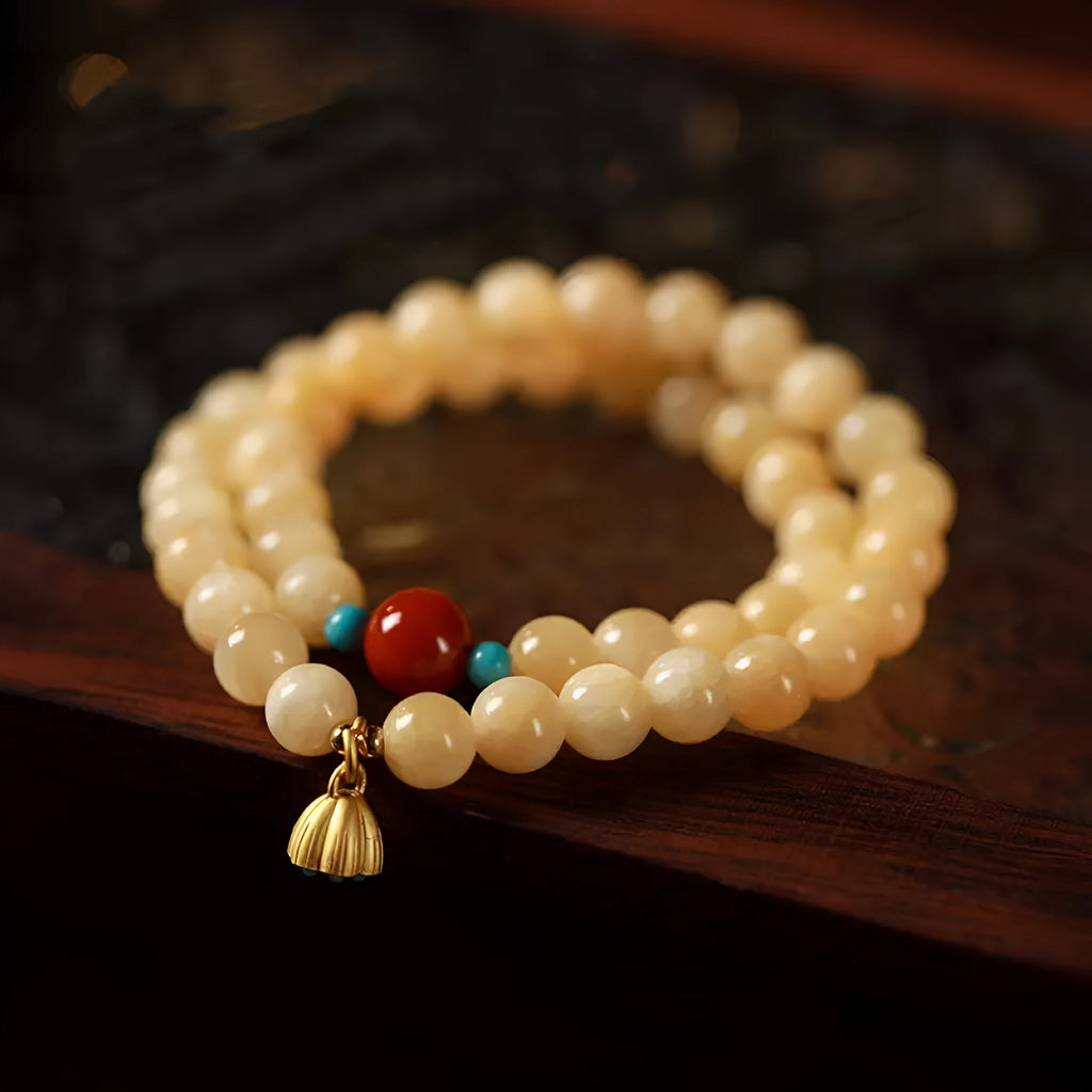 Yellow jade coloured topaz bracelet with double ring design and lotus seedpod beads