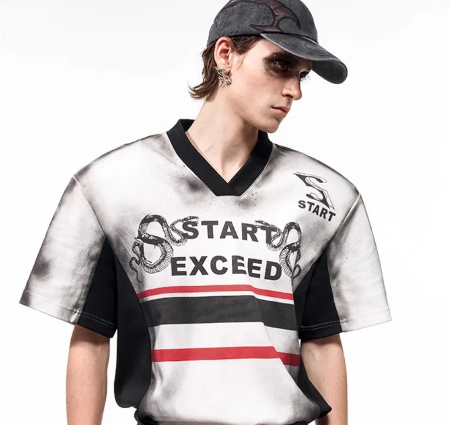 Women's V-neck short sleeve top with black and white letter snake pattern print and padded shoulders.