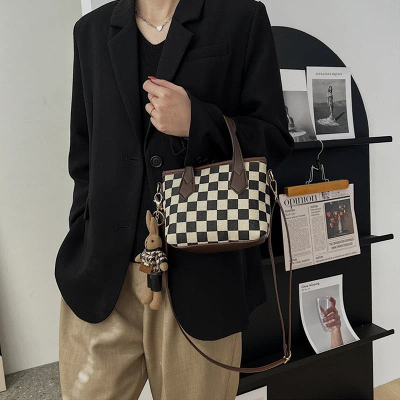 Stylish houndstooth shoulder bags in various colors, featuring a spacious square shape, adjustable strap, and classic checkerboard pattern.